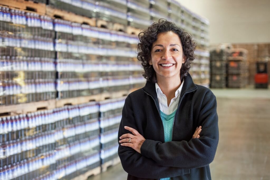 Portrait of an African American female manager in a storage warehouse of pallets